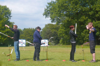 Schülerinnen und Schüler lernen das Bogen schießen